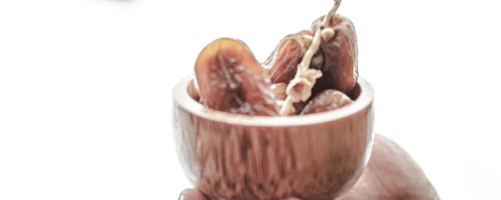 two hands holding a small bowl of food