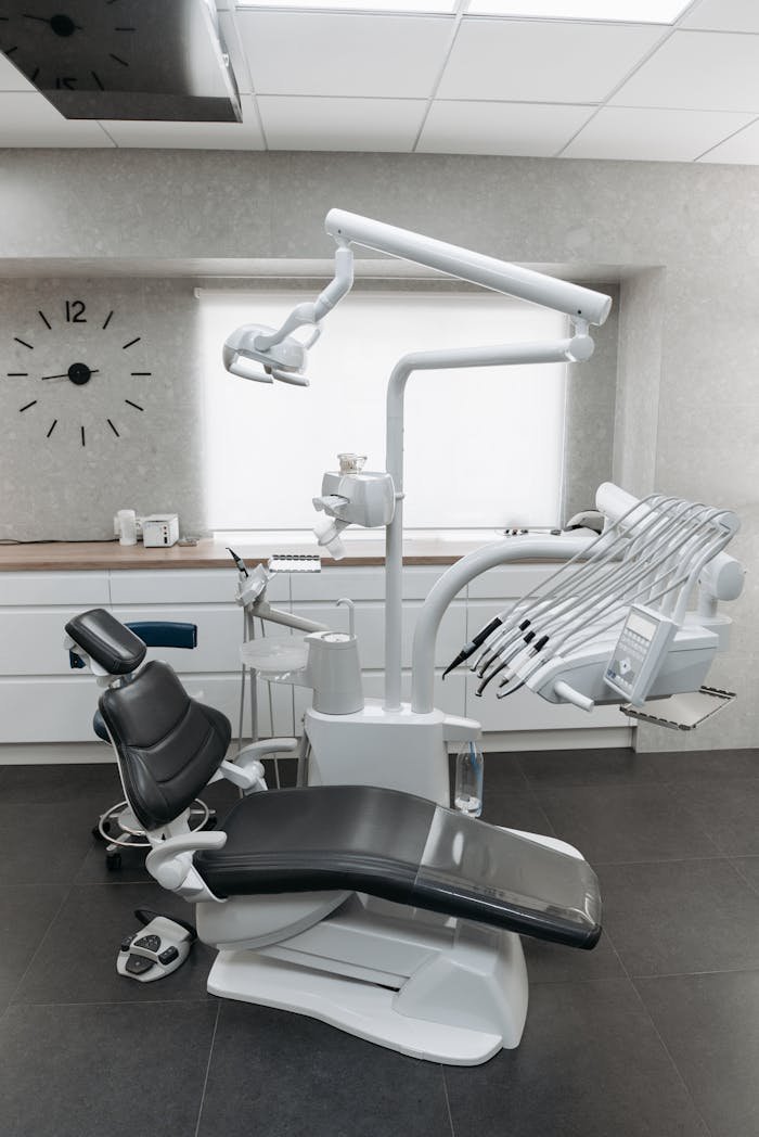 who-we-are Clean and modern dental office interior with advanced equipment and dental chair.