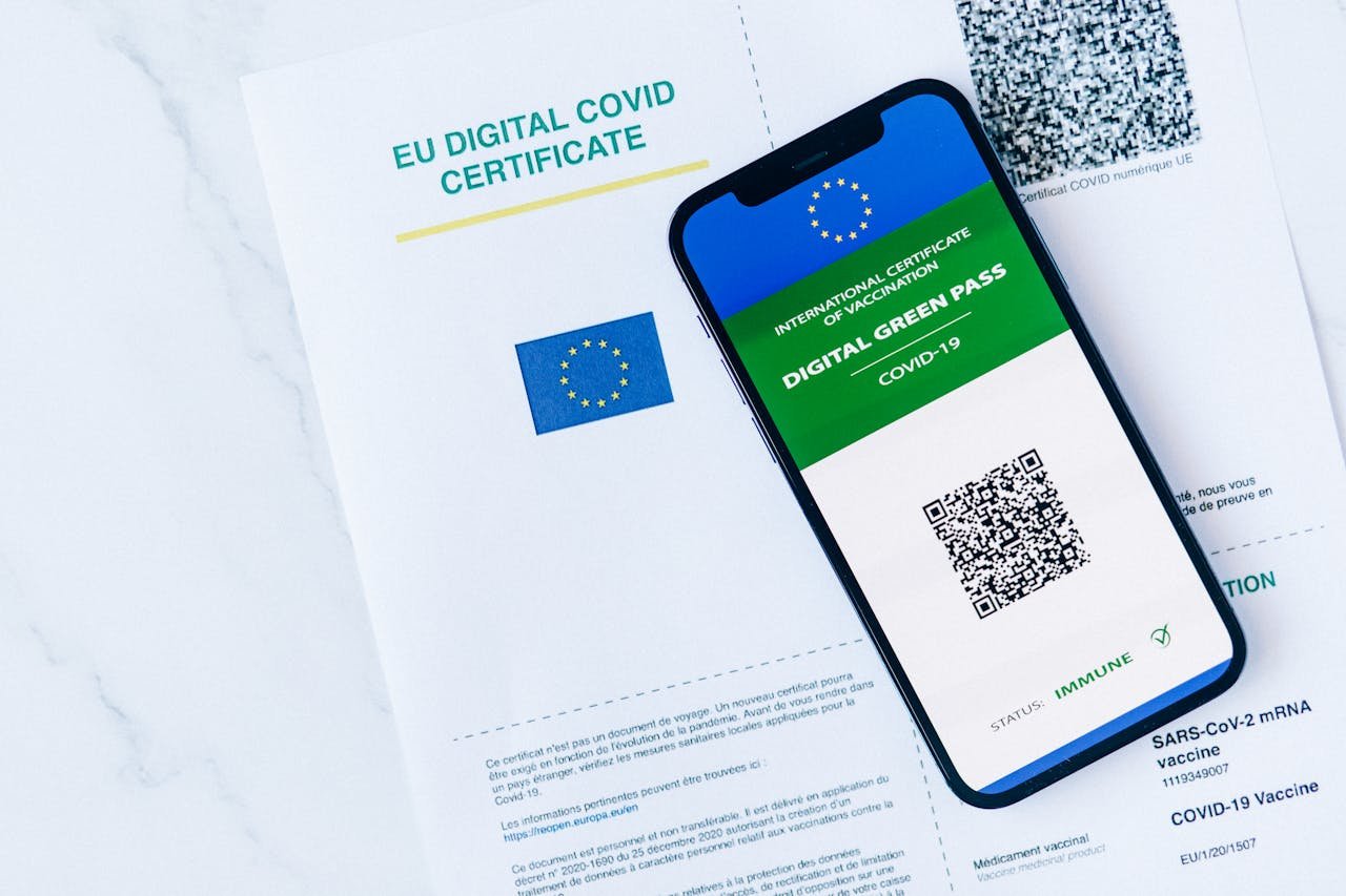 team-03 EU Digital COVID Certificate displayed on smartphone and paper form, vaccination proof.